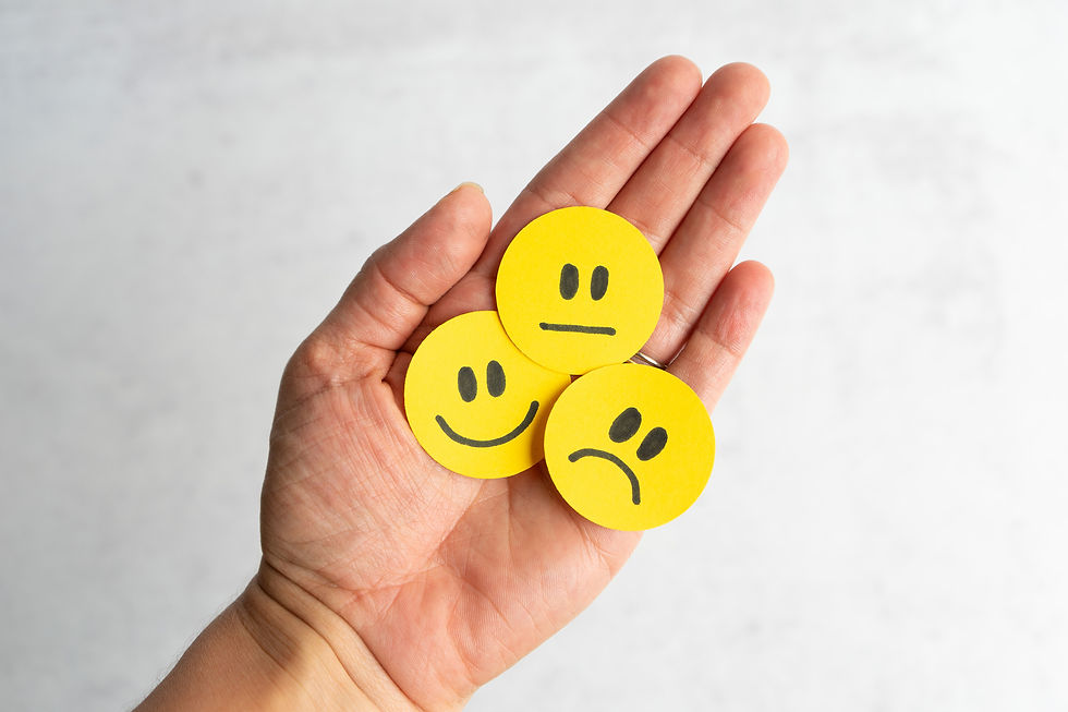 Man holding out paper cuts of different emotions